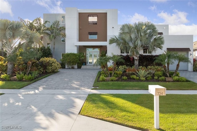 724 Plantation Ct, Marco Island, FL 34145 - view of front facade featuring a front lawn, stucco siding, and decorative driveway