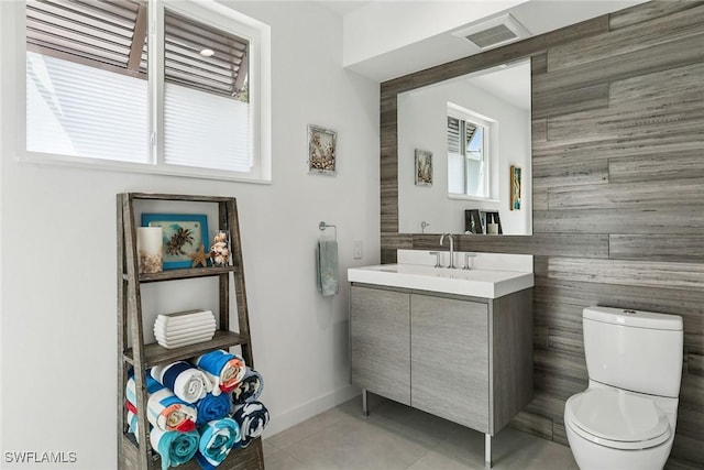 724 Plantation Ct, Marco Island, FL 34145 - bathroom with toilet, tile patterned floors, vanity, and baseboards