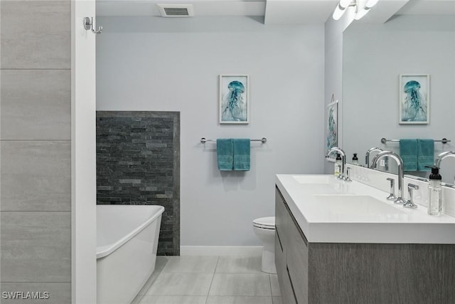 724 Plantation Ct, Marco Island, FL 34145 - full bath with a freestanding tub, toilet, baseboards, double vanity, and tile patterned flooring