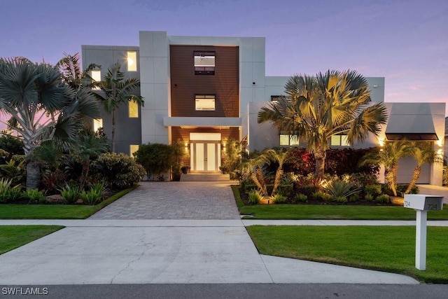 724 Plantation Ct, Marco Island, FL 34145 - contemporary house featuring french doors, a front lawn, and stucco siding