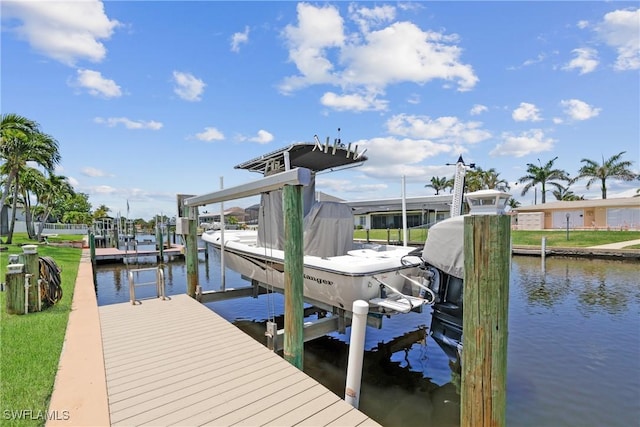 dock area with boat lift and a water view