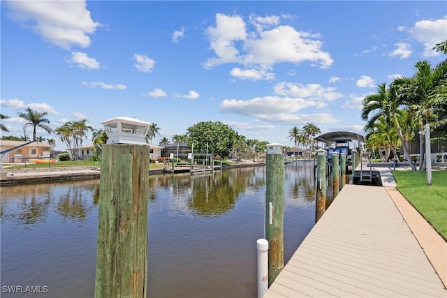 view of dock with boat lift and a water view