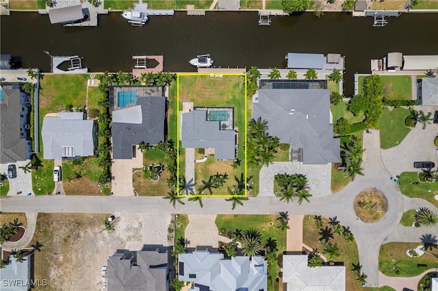 drone / aerial view with a water view and a residential view