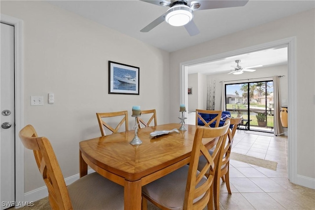 dining space featuring baseboards, a ceiling fan, and light tile patterned floors