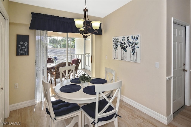 3665 Buttonwood Way Unit 1422, Naples, FL 34112 - dining space with baseboards, an inviting chandelier, and light wood-style flooring