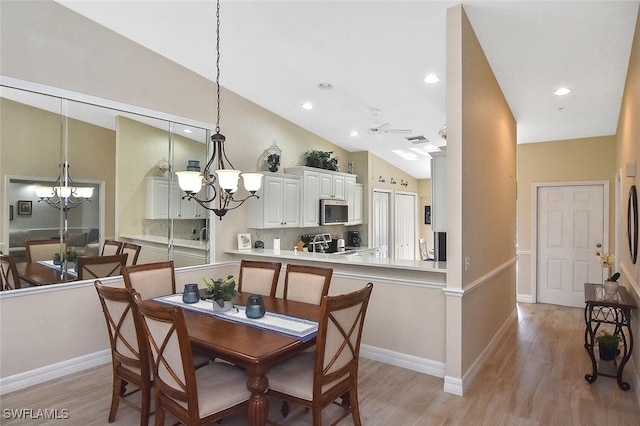 3665 Buttonwood Way Unit 1422, Naples, FL 34112 - dining space with baseboards, a notable chandelier, light wood-style flooring, and high vaulted ceiling