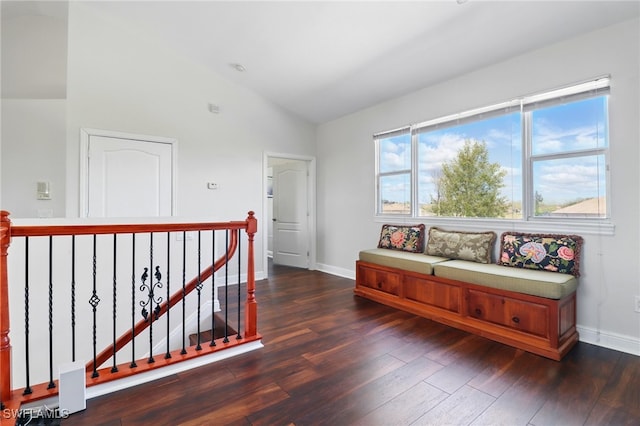sitting room featuring baseboards, an upstairs landing, dark wood finished floors, and lofted ceiling