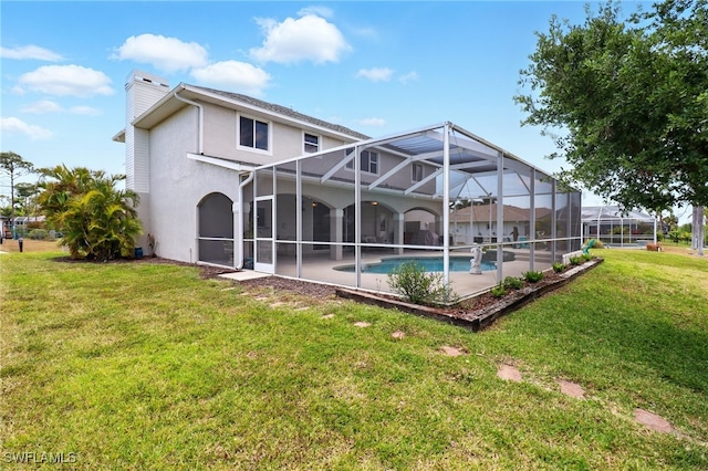 back of property featuring stucco siding, an outdoor pool, a chimney, a lawn, and a patio