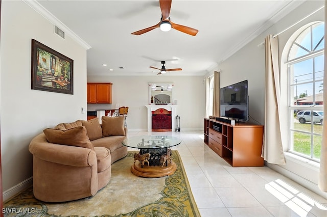 living room with crown molding, a ceiling fan, baseboards, light tile patterned floors, and visible vents
