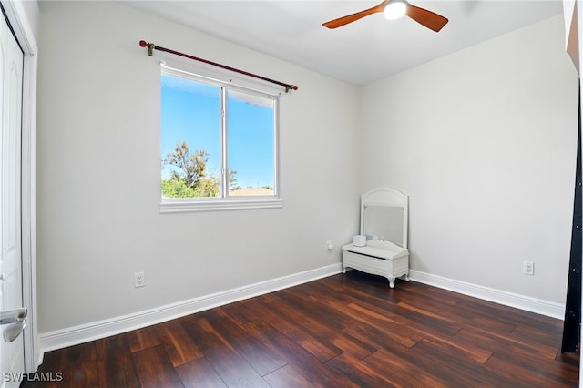 empty room featuring baseboards, a ceiling fan, and wood finished floors