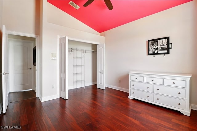 bedroom featuring visible vents, dark wood finished floors, baseboards, and vaulted ceiling