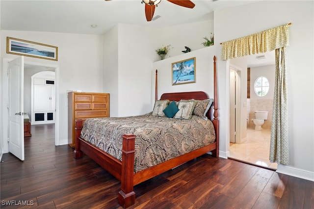 bedroom with baseboards, ceiling fan, a high ceiling, and hardwood / wood-style floors