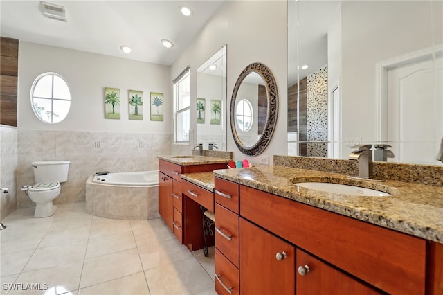 full bath with visible vents, a garden tub, tile patterned flooring, vanity, and toilet