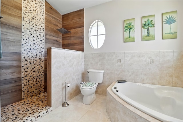 full bathroom featuring a walk in shower, toilet, tile patterned floors, tile walls, and a bath