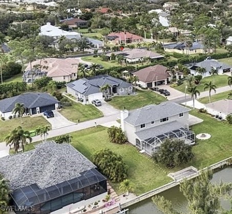birds eye view of property featuring a residential view and a water view