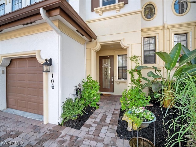 15780 Portofino Springs Blvd Unit 106, Fort Myers, FL 33908 - doorway to property with a garage and stucco siding