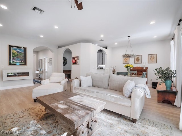 15780 Portofino Springs Blvd Unit 106, Fort Myers, FL 33908 - living area featuring visible vents, arched walkways, light wood finished floors, and recessed lighting