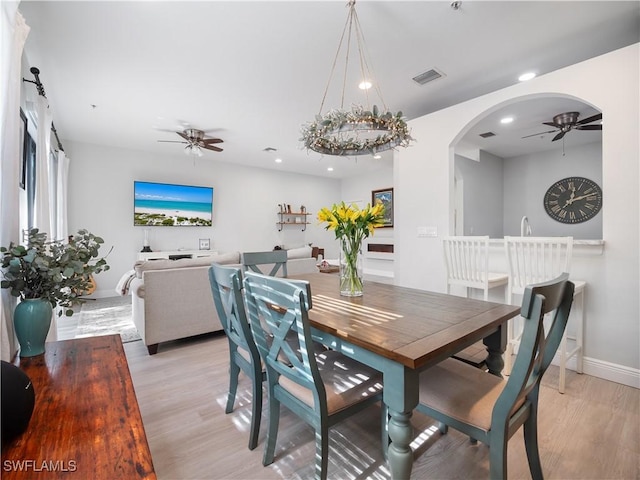 15780 Portofino Springs Blvd Unit 106, Fort Myers, FL 33908 - dining room with light wood-style floors, baseboards, ceiling fan, and arched walkways