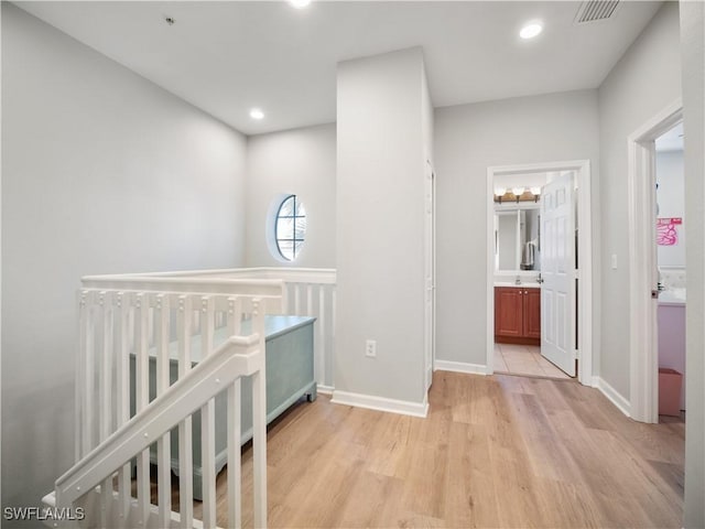 15780 Portofino Springs Blvd Unit 106, Fort Myers, FL 33908 - corridor with baseboards, recessed lighting, light wood-style flooring, and visible vents