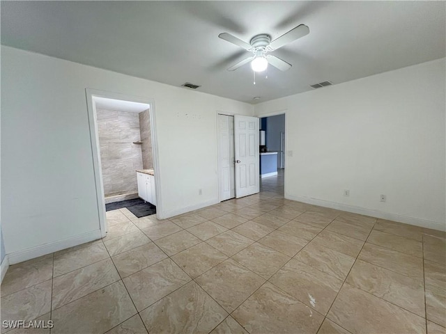 2432 Vernon Ave S, Lehigh Acres, FL 33973 - spare room with a ceiling fan, baseboards, and light tile patterned flooring