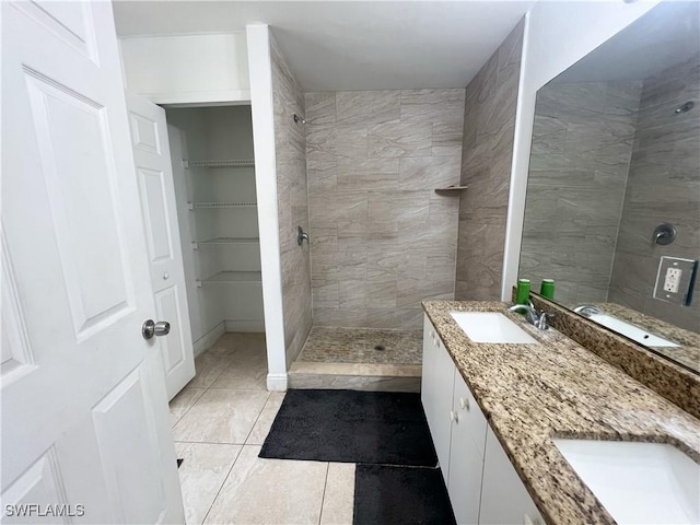 2432 Vernon Ave S, Lehigh Acres, FL 33973 - bathroom featuring tile patterned flooring, tiled shower, and double vanity