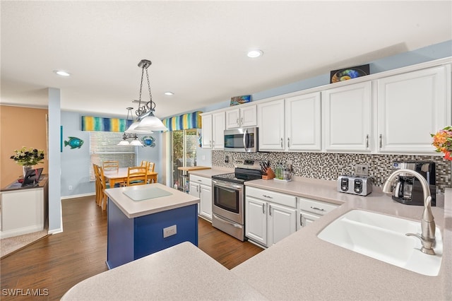 kitchen with a sink, white cabinetry, tasteful backsplash, and stainless steel appliances