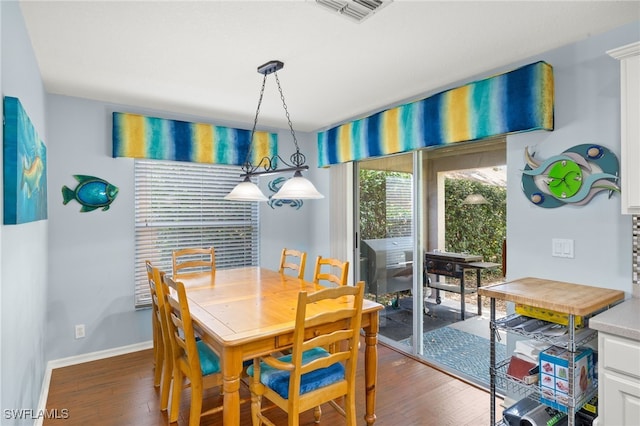 dining space featuring baseboards, visible vents, and wood finished floors