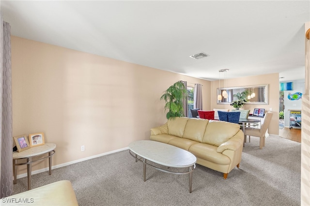 carpeted living area with baseboards and visible vents