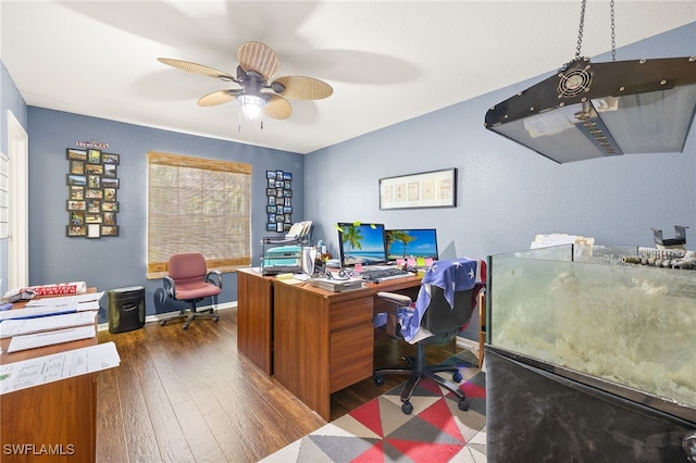 home office featuring ceiling fan, baseboards, and hardwood / wood-style flooring