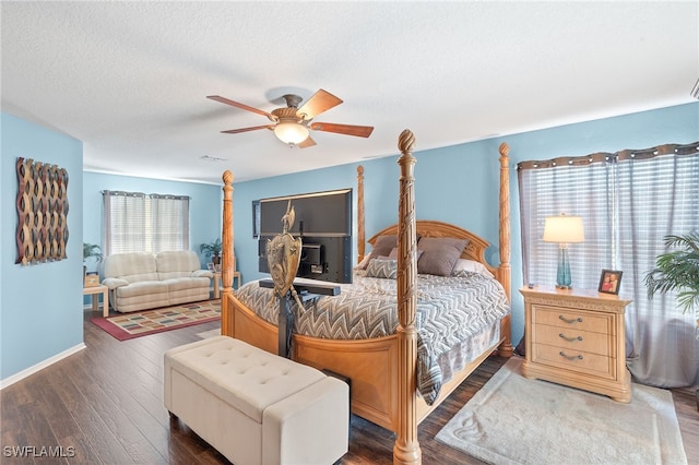bedroom with baseboards, ceiling fan, a textured ceiling, and wood finished floors