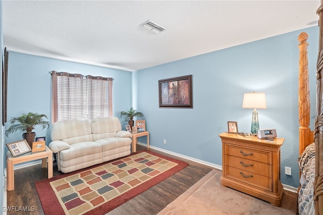 living room with baseboards, wood finished floors, and visible vents