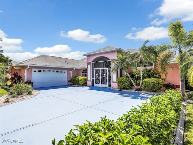 1800 SE 21st St, Cape Coral, FL 33990 - mediterranean / spanish-style home featuring a garage, stucco siding, and concrete driveway
