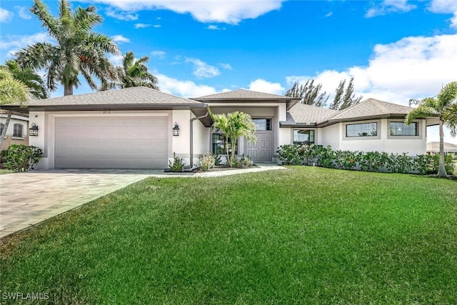 2016 SW 28th Ln, Cape Coral, FL 33914 - prairie-style house with a garage, stucco siding, a front lawn, and driveway