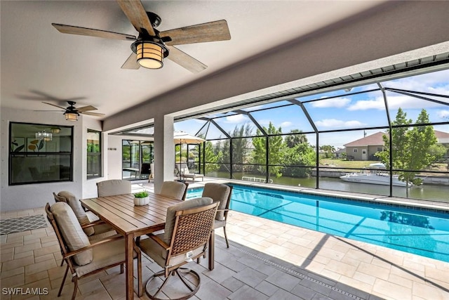 2016 SW 28th Ln, Cape Coral, FL 33914 - pool with ceiling fan, a patio, outdoor dining area, and glass enclosure
