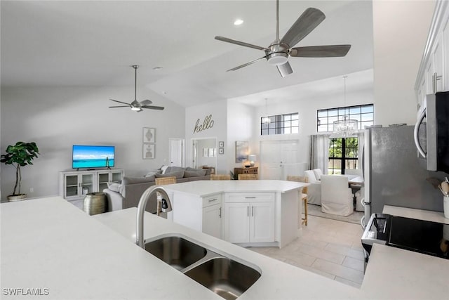 2016 SW 28th Ln, Cape Coral, FL 33914 - kitchen with ceiling fan with notable chandelier, a sink, open floor plan, white cabinets, and appliances with stainless steel finishes