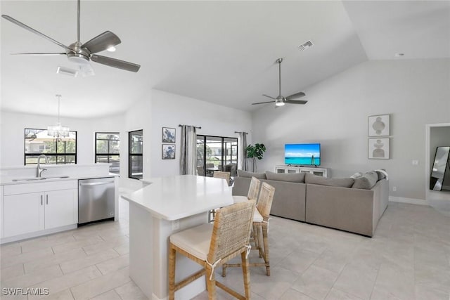 2016 SW 28th Ln, Cape Coral, FL 33914 - kitchen with ceiling fan with notable chandelier, high vaulted ceiling, a sink, visible vents, and dishwasher
