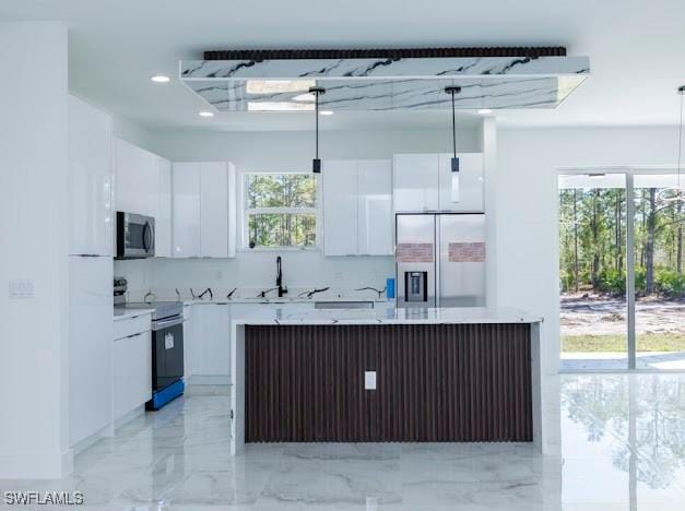 kitchen featuring decorative light fixtures, a center island, marble finish floor, stainless steel appliances, and white cabinetry