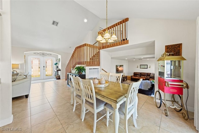 209 SE 3rd Ter, Cape Coral, FL 33990 - dining space featuring light tile patterned floors, stairs, visible vents, and high vaulted ceiling