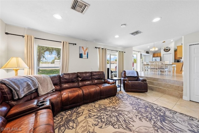 209 SE 3rd Ter, Cape Coral, FL 33990 - living area with light tile patterned floors, a wealth of natural light, and visible vents