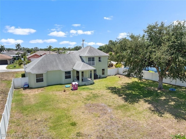 209 SE 3rd Ter, Cape Coral, FL 33990 - back of house with roof with shingles, a lawn, and a fenced backyard