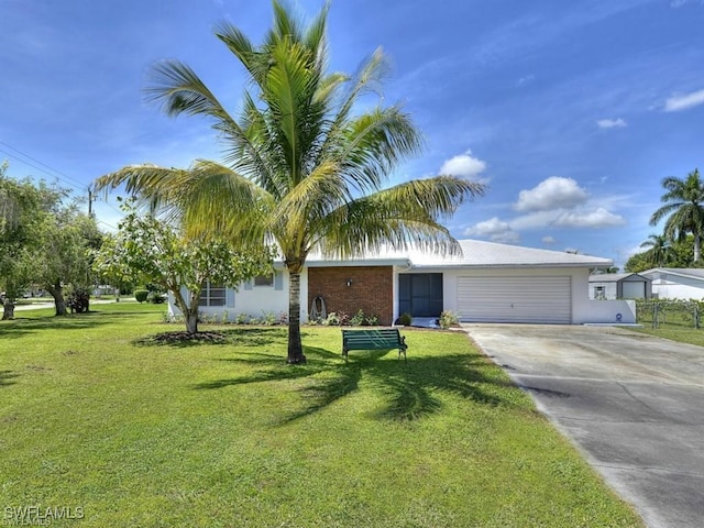 303 Georgia Ave, Fort Myers, FL 33905 - ranch-style house featuring driveway, an attached garage, fence, and a front yard
