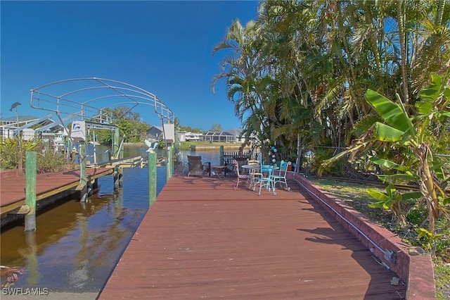 303 Georgia Ave, Fort Myers, FL 33905 - view of dock featuring boat lift and a water view