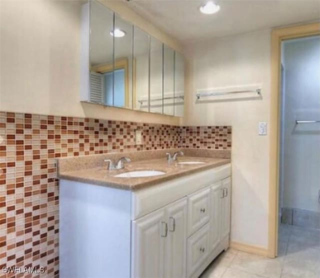 303 Georgia Ave, Fort Myers, FL 33905 - full bathroom with a sink, double vanity, backsplash, and tile patterned floors