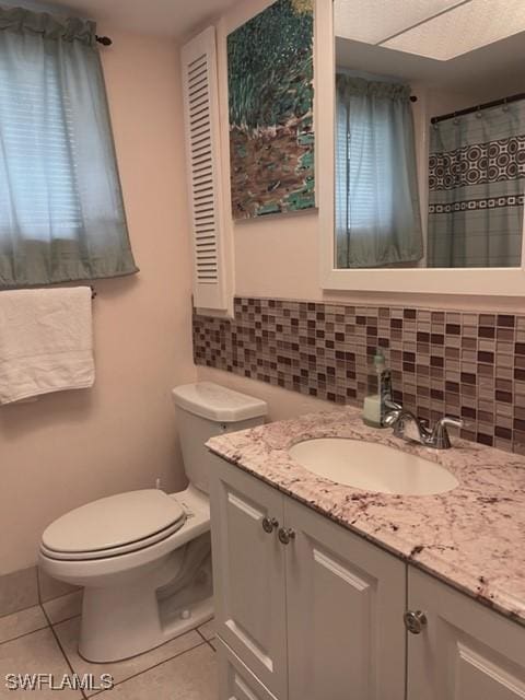 303 Georgia Ave, Fort Myers, FL 33905 - bathroom featuring tile patterned floors, toilet, tasteful backsplash, and vanity