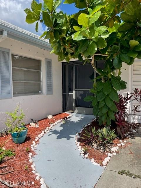 303 Georgia Ave, Fort Myers, FL 33905 - view of exterior entry featuring stucco siding
