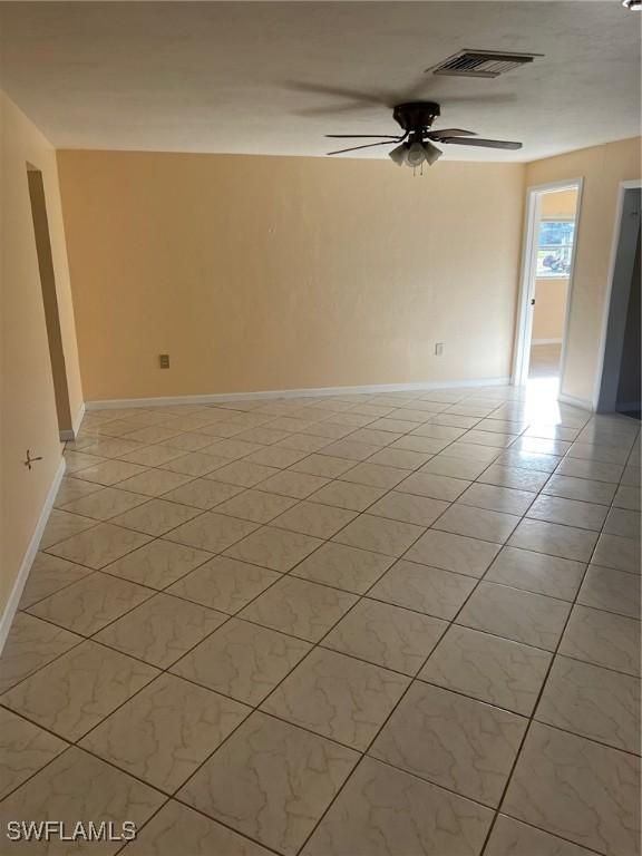 303 Georgia Ave, Fort Myers, FL 33905 - unfurnished room featuring a ceiling fan, baseboards, visible vents, and light tile patterned flooring