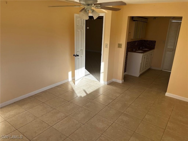 303 Georgia Ave, Fort Myers, FL 33905 - empty room featuring light tile patterned floors, baseboards, ceiling fan, and a sink
