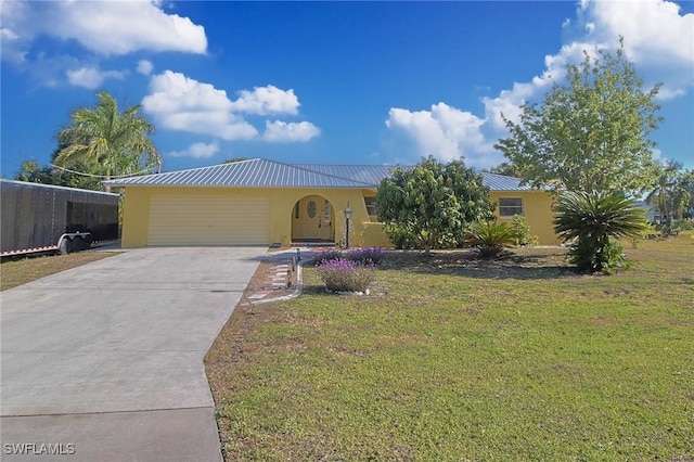 147 Coral Dr, Fort Myers, FL 33905 - single story home with an attached garage, concrete driveway, stucco siding, metal roof, and a front lawn