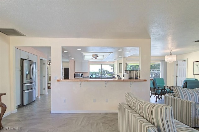147 Coral Dr, Fort Myers, FL 33905 - living area with baseboards, an inviting chandelier, and plenty of natural light