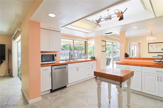 147 Coral Dr, Fort Myers, FL 33905 - kitchen featuring a sink, recessed lighting, butcher block countertops, and appliances with stainless steel finishes